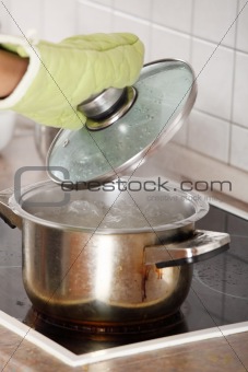 Young woman boiling something in pot