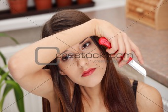 Young woman peeling potato