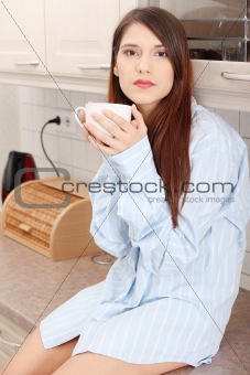 A young woman having morning coffee 