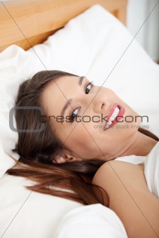 Portrait of beautiful smiling woman on bed