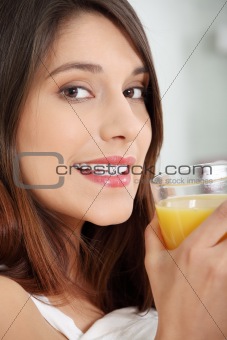 Woman in bed drinking orange juice