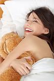 Girl in bed with teddy bear 