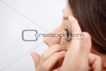 Woman putting a contact lens