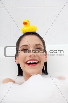 Beautiful young caucasian woman taking a bath