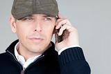Confident Man In Newsboy Hat Talks On His Cell Phone
