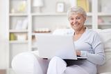 An elderly woman with a laptop
