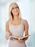Blond woman reading book
