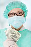 Female surgeon doctor holding money