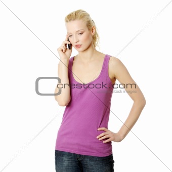 Young woman getting bad news by phone.