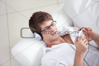 A young man listens to music