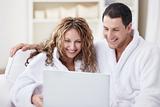 Laughing couple with laptop