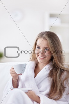 Beautiful girl drinking coffee at home