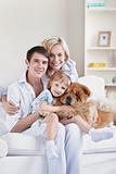 Smiling family with a dog