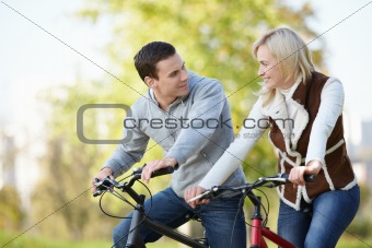 Attractive couple on bicycles