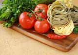 Italian pasta, olive oil and tomatoes on an old vintage background