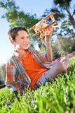 Young Boy Outside Playing With His Model Airplane
