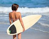 Adorable woman with her surfboard