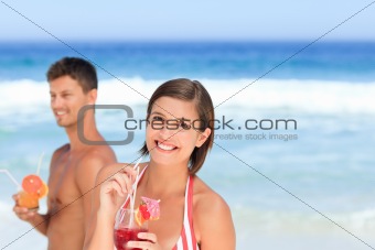 Adorable couple drinking a cocktail