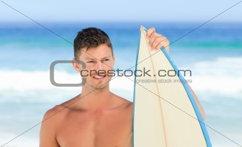 Handsome man with his surfboard