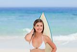 Cute woman with her surfboard