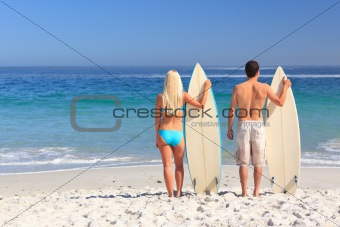 Couple with their surfboards
