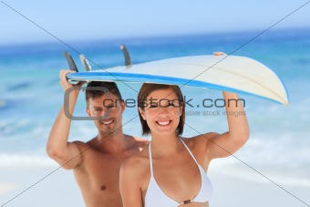 Lovers with their surfboard