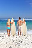 Lovers with their surfboards