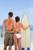 Couple with their surfboard