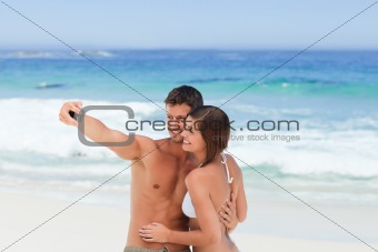 Lovers with their camera at the beach