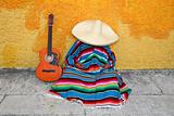 Mexican typical lazy man sombrero hat guitar serape