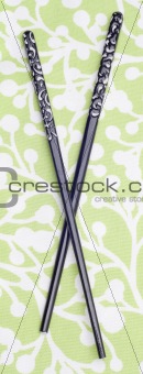 Black Chopsticks on Green Patterned Background