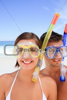 Couple with their mask at the beach