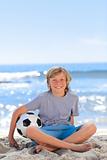 Boy  with his ball on the beach