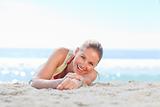 A woman sunbathing on the beach