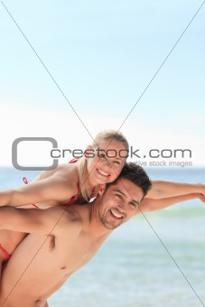 Beautiful man having girlfriend a piggyback
