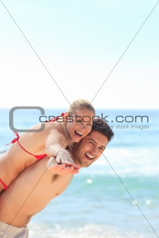 Beautiful man having girlfriend a piggyback