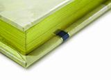 Close up of a green colored journal on white