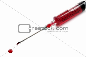 Syringe and needle filled with blood