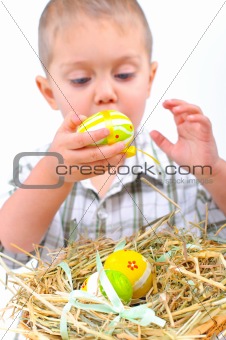 Little boy with easter eggs in basket