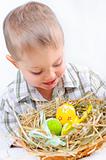 Little boy with easter eggs in basket