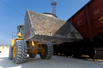 excavator loads gravel