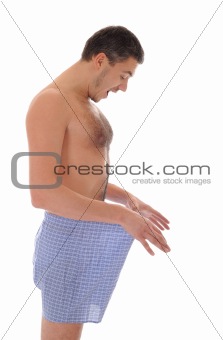 Young sexy handsome man looking in his pants 
