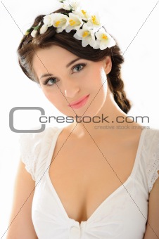 Beautiful spring woman with pure skin and flowers in her hair