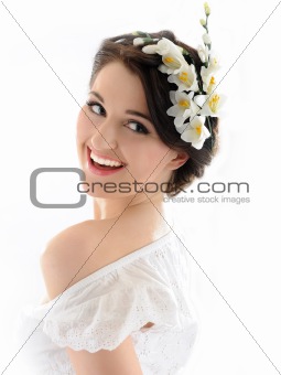 Beautiful spring woman with pure skin and flowers in her hair