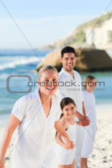Portrait of a cute family at the beach
