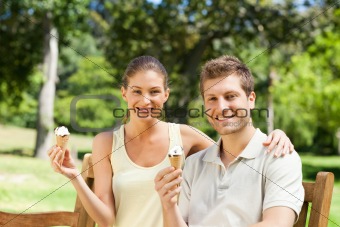 Couple eating an ice cream in the park