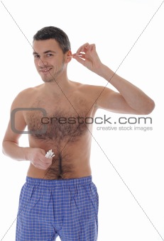 handsome young man cleaning ears with cotton pad stick. isolated