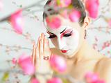 japan geisha woman with creative make-up in sakura garden.