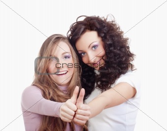 two young women showing thumbs up, smiling - isolated on white