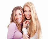 portrait of two sisters with long hair standing smiling - isolated on white